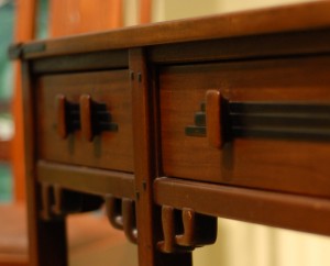 A detail of the Blacker table showing brackets and wood drawer pull.
