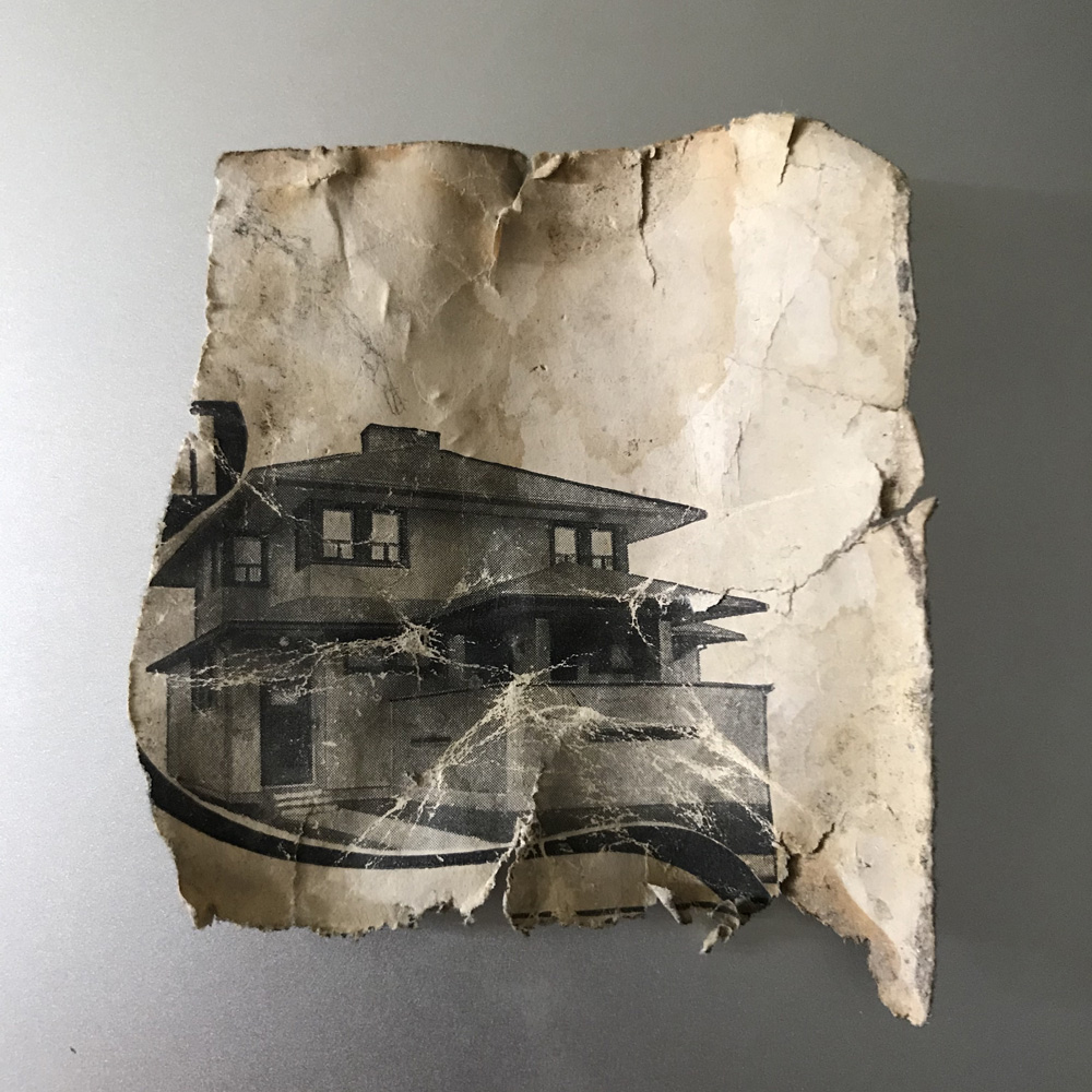 A small fragment of a Popular Mechanics cover contains the image of a prairie style house.